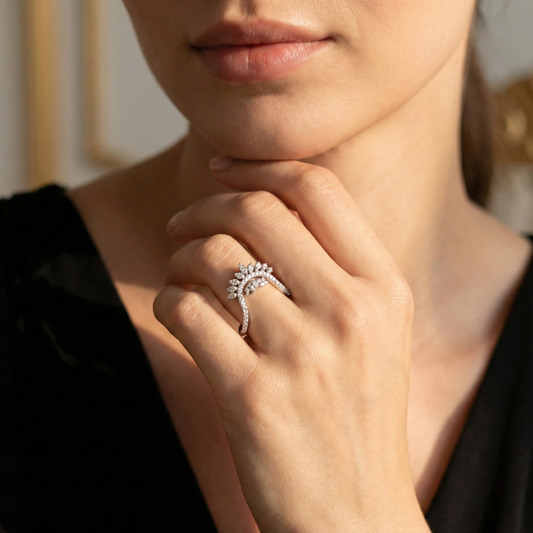 Close-up of a hand wearing a diamond ring with a blurred background