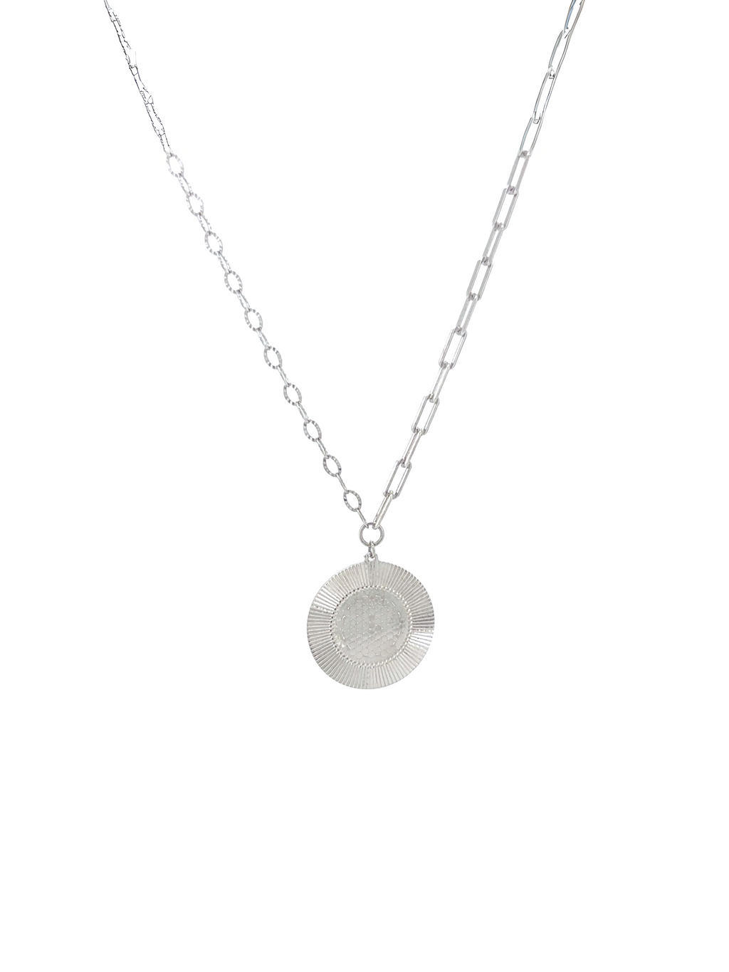 A silver necklace featuring a textured circular disc pendant suspended from a fine link chain, shown against a plain white background.