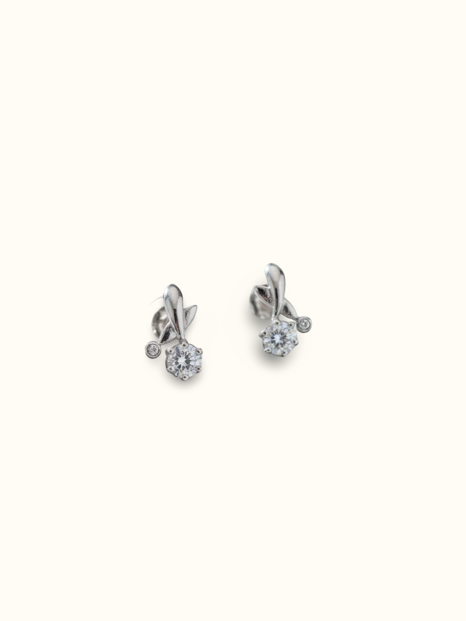 These elegant silver earrings feature a delicate floral-inspired design with sparkling zircon details.
The sculpted silver accents and brilliant centre stones add a graceful touch of sparkle to any look.