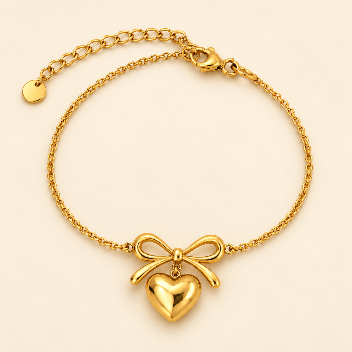 Gold-toned stainless steel bracelet featuring a polished bow-shaped centrepiece and a dangling heart charm.
Delicate chain bracelet with an adjustable extension, displayed on a clean pink background.