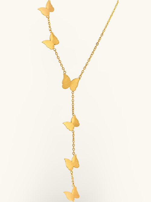 Gold-toned butterfly lariat necklace featuring three smooth butterfly charms arranged along a delicate cascading chain.

Close-up of a gold butterfly necklace with a central butterfly and two dangling butterfly charms against a white background.
