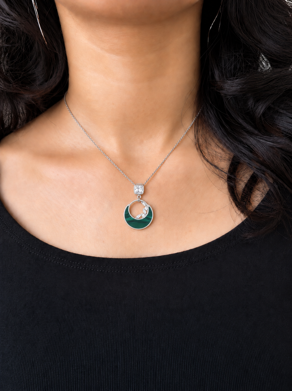 Model wearing a silver green moon pendant