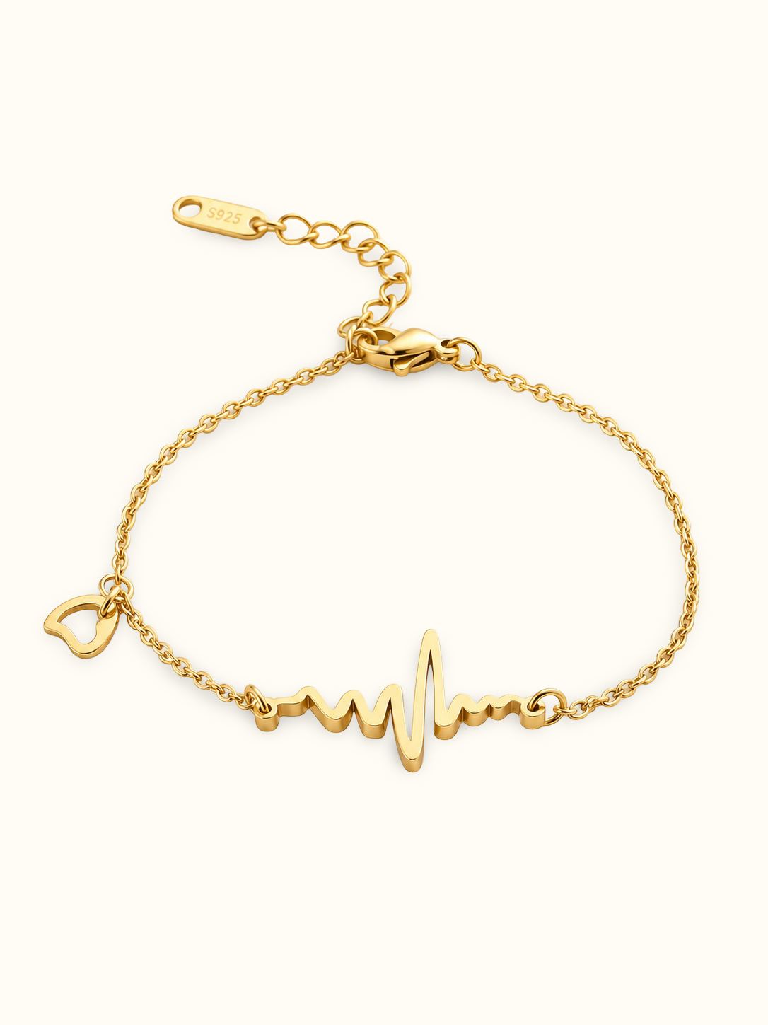 A delicate gold chain bracelet with a heartbeat line and heart charm, displayed against a light background.