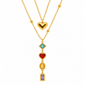Gold-toned layered necklace with a glossy heart charm and a cascading pendant featuring blue, red, yellow and purple stones.
Colourful statement necklace with decorative gold-toned settings and delicate chains against a light background.