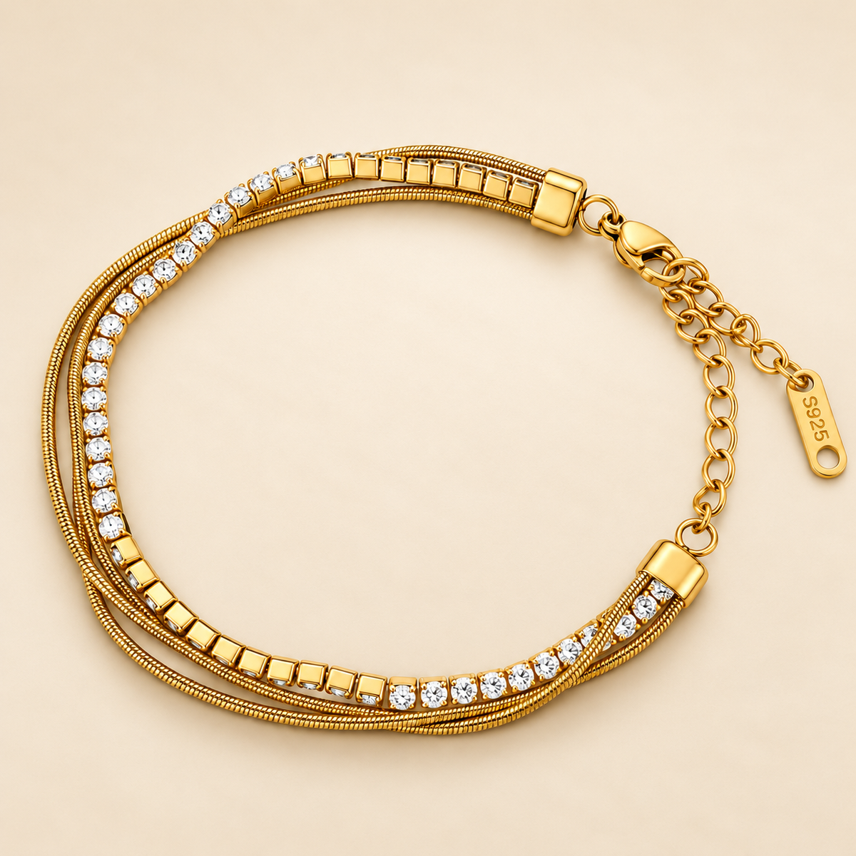 Gold-toned stainless steel multi-strand bracelet featuring clear sparkling stones and polished square accents.
Layered chain bracelet with an adjustable extension and lobster clasp, displayed on a clean pink background.