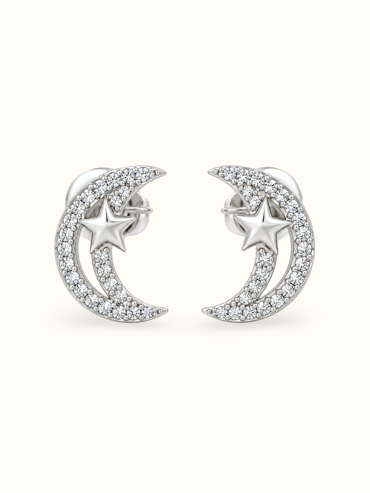 Silver crescent moon and star stud earrings with sparkling clear zircons displayed against a white background.