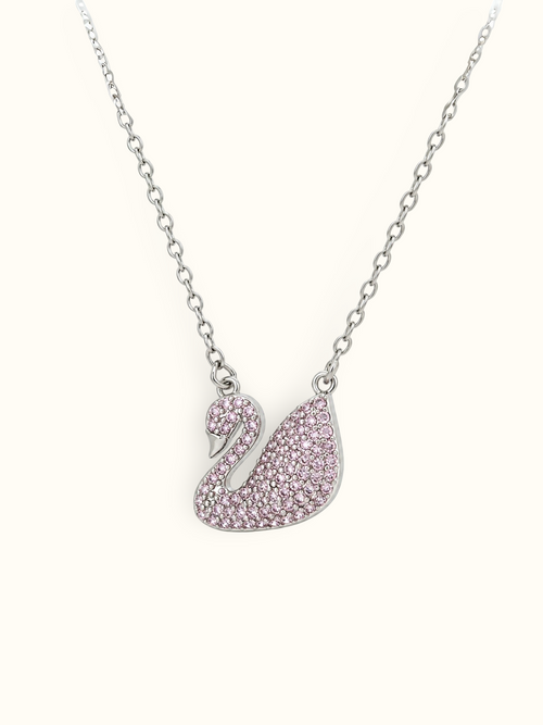 Silver-toned swan pendant necklace embellished with blush-pink sparkling stones and polished detailing.
Elegant pink swan charm suspended from a delicate silver-toned link chain against a white background.