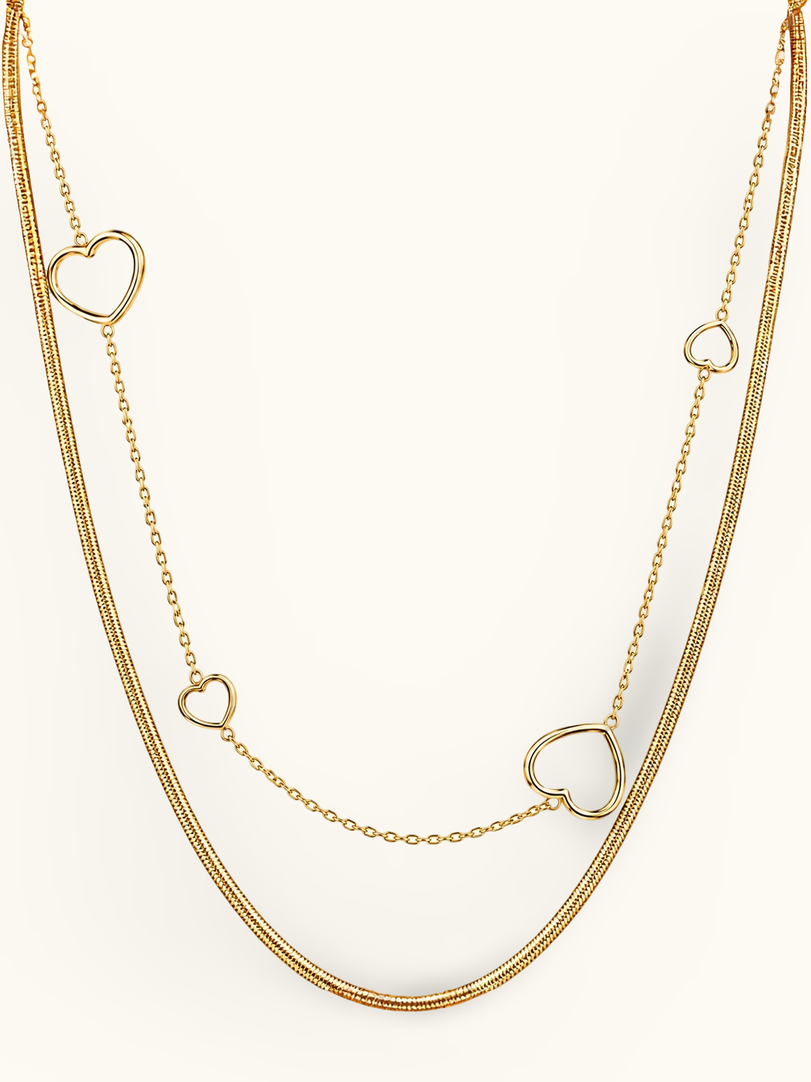 Gold-toned layered necklace featuring a smooth snake chain and a delicate fine-link chain with open teardrop-shaped accents.
Minimal two-layer gold necklace with contrasting chain textures, styled against a light background.