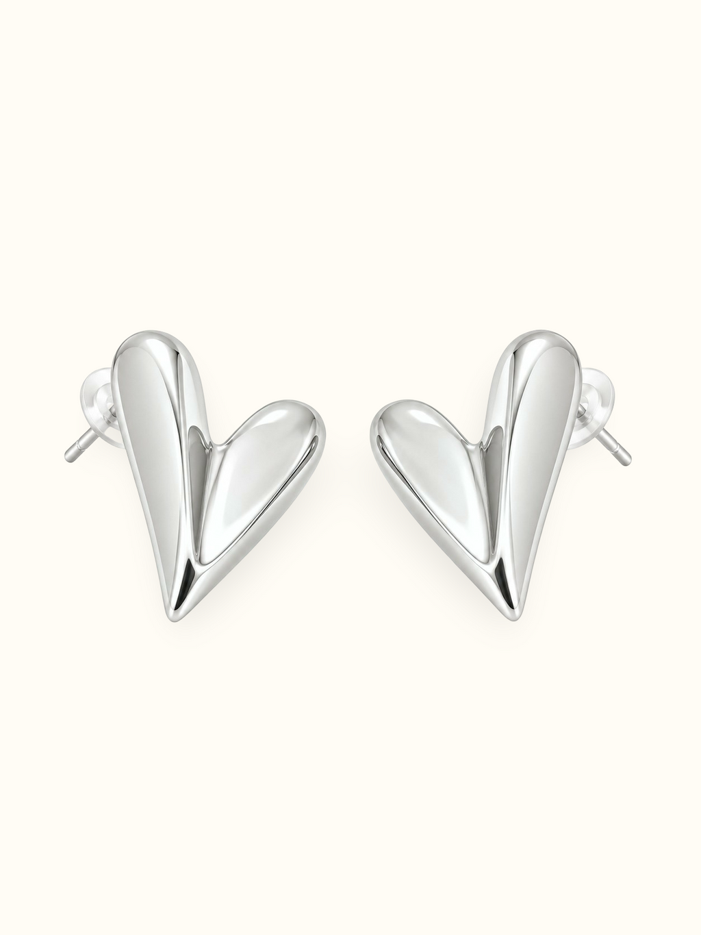 Silver-tone sculpted heart stud earrings with an abstract curved design and polished finish displayed against a white background.