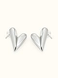 Silver-tone sculpted heart stud earrings with an abstract curved design and polished finish displayed against a white background.