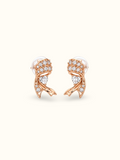 Rose gold-tone ribbon heart stud earrings featuring sparkling clear stones, heart-shaped crystal accents and intricate curved metal detailing displayed against a cream background.