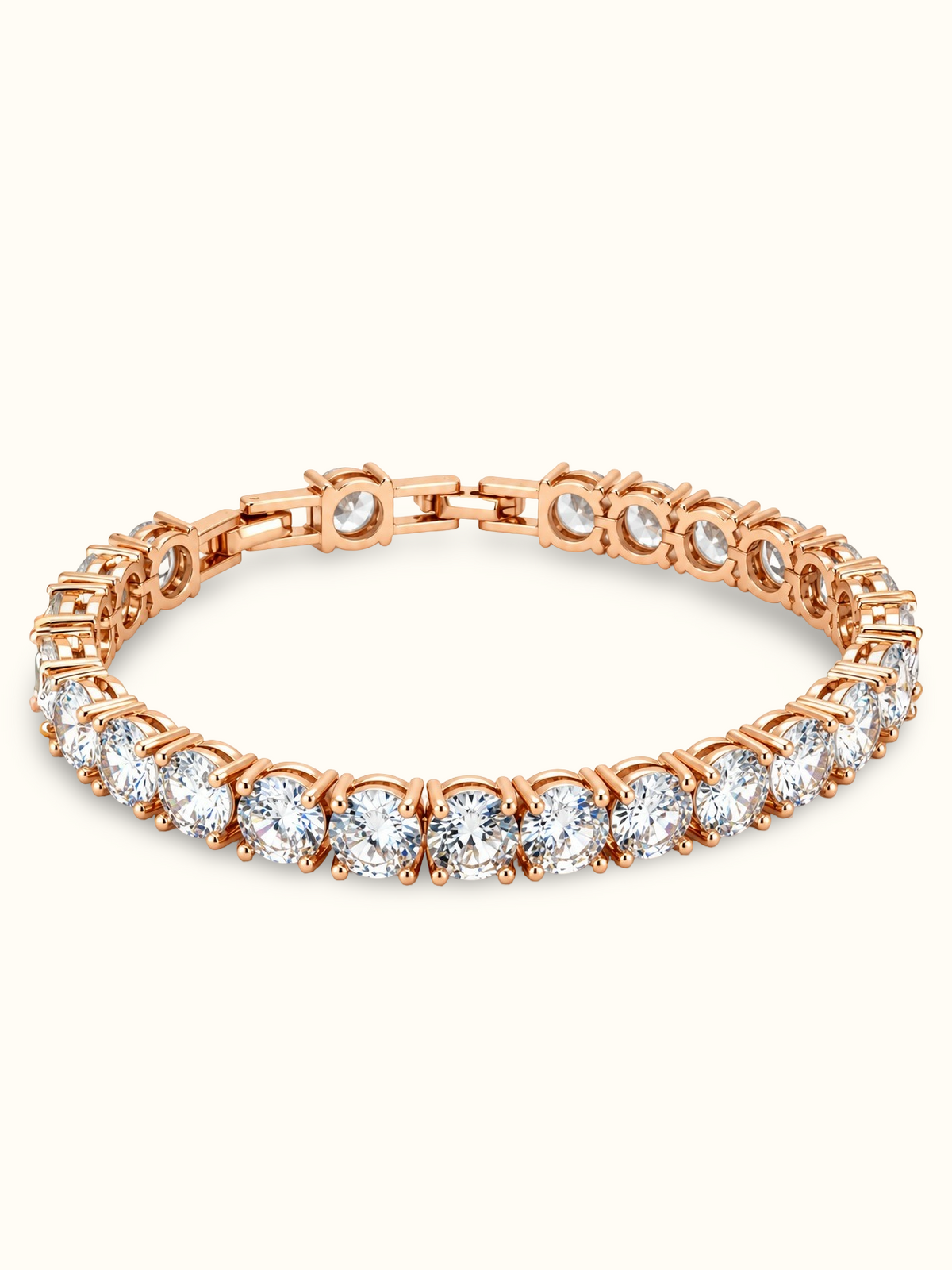 Rose gold-toned tennis bracelet featuring a continuous row of brilliant round-cut clear stones in prong-style settings.
Classic linked bracelet design with a sparkling finish, displayed on a clean off-white background.