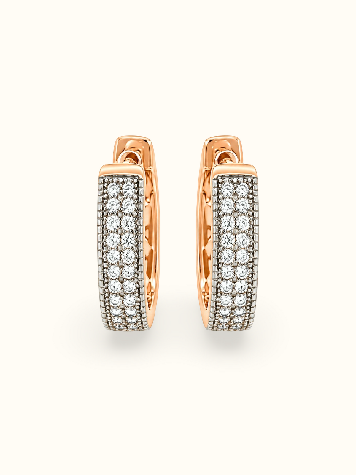 Rose gold-tone hoop earrings with clear sparkling stones and a dark textured base displayed against a white background.