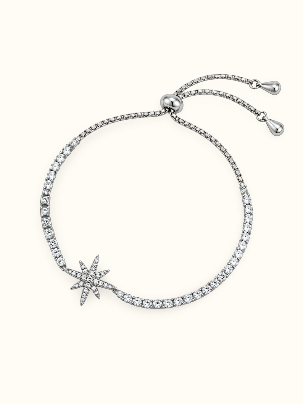 Silver-toned Celestial Starburst Bracelet featuring a multi-point star charm decorated with sparkling clear stones.
Adjustable bolo-style bracelet with round and square stone accents along the band, displayed on a light background.
