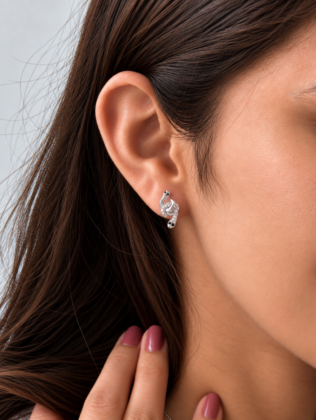 Model wearing silver snake earring