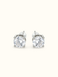 Silver-tone round solitaire stud earrings with large clear stones in four-prong settings.