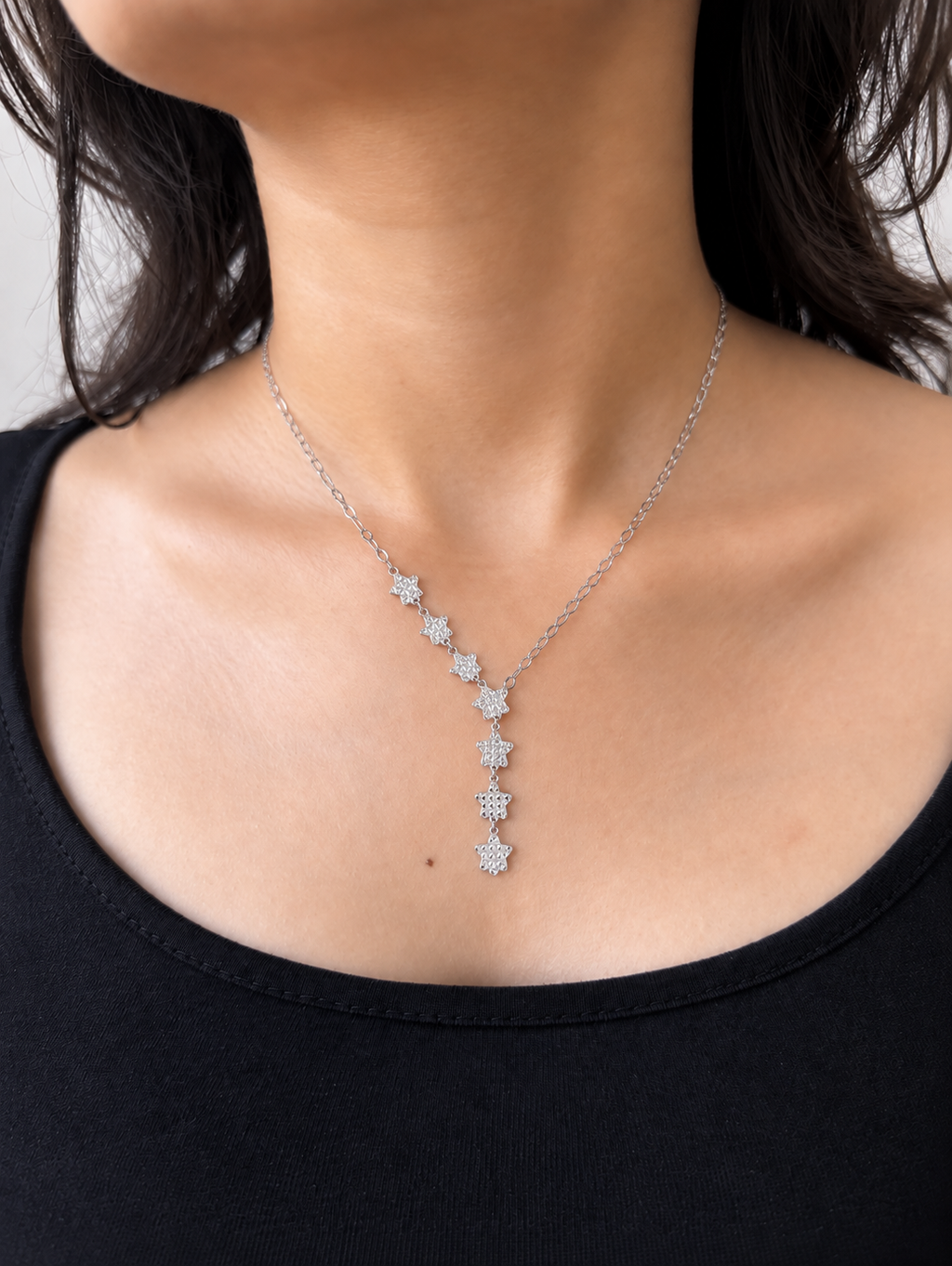 Model wearing a star studded necklace