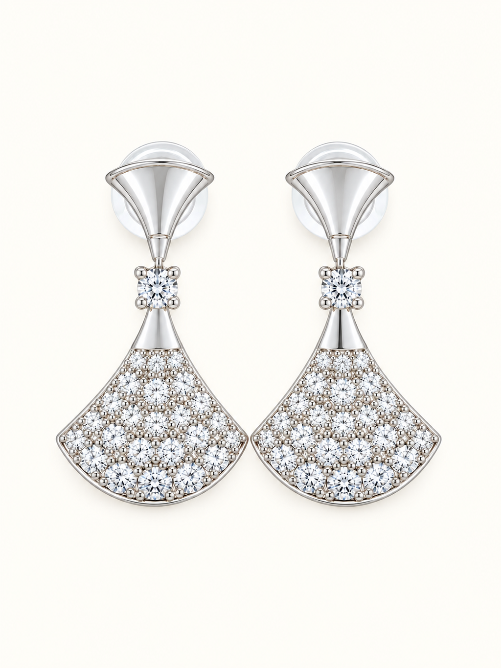 Silver-tone fan drop earrings embellished with clear sparkling stones and polished geometric detailing on a white background.