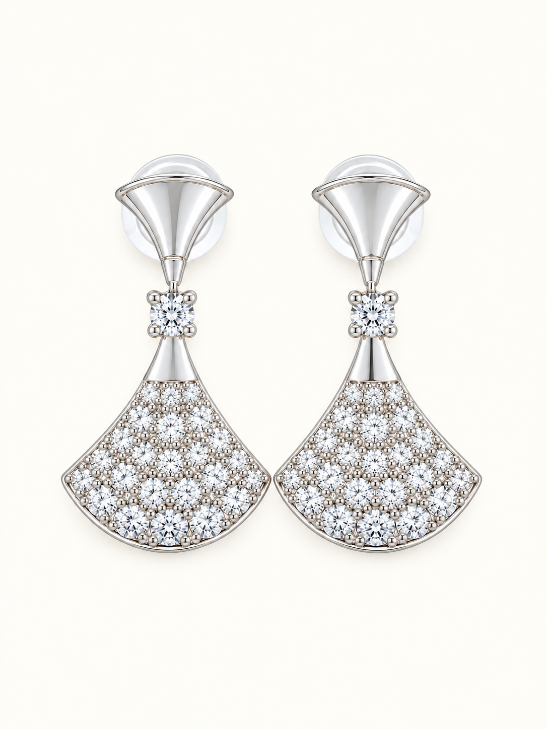 Silver-tone fan drop earrings embellished with clear sparkling stones and polished geometric detailing on a white background.