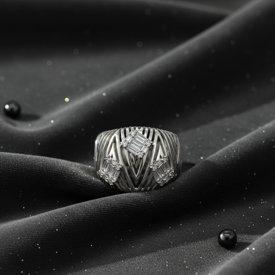 Silver ring with geometric design on a black textured surface