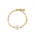 Gold-toned stainless steel bracelet featuring elongated chain links and an oval white enamel charm with a blue evil eye motif.
Gold-link bracelet with a textured border and adjustable extension, displayed on a clean white background.