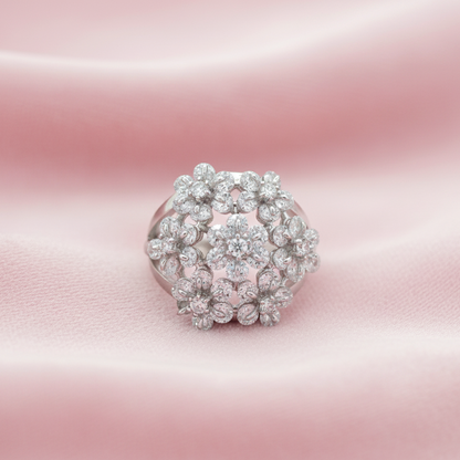 Silver floral-cascade-ring-modern-indian-jewellery ring with diamond cluster on a pink satin background