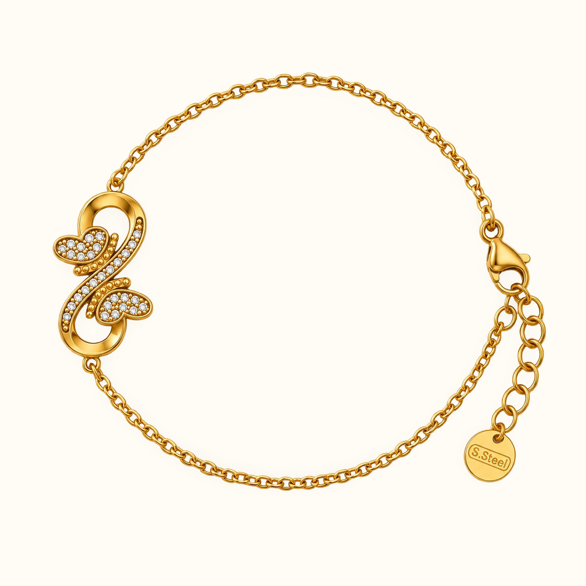 A gold chain bracelet with a decorative openwork clasp adorned with small clear stones, shown on a plain light background. 
