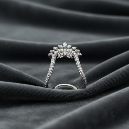 Silver ring with diamond accents on a dark fabric background