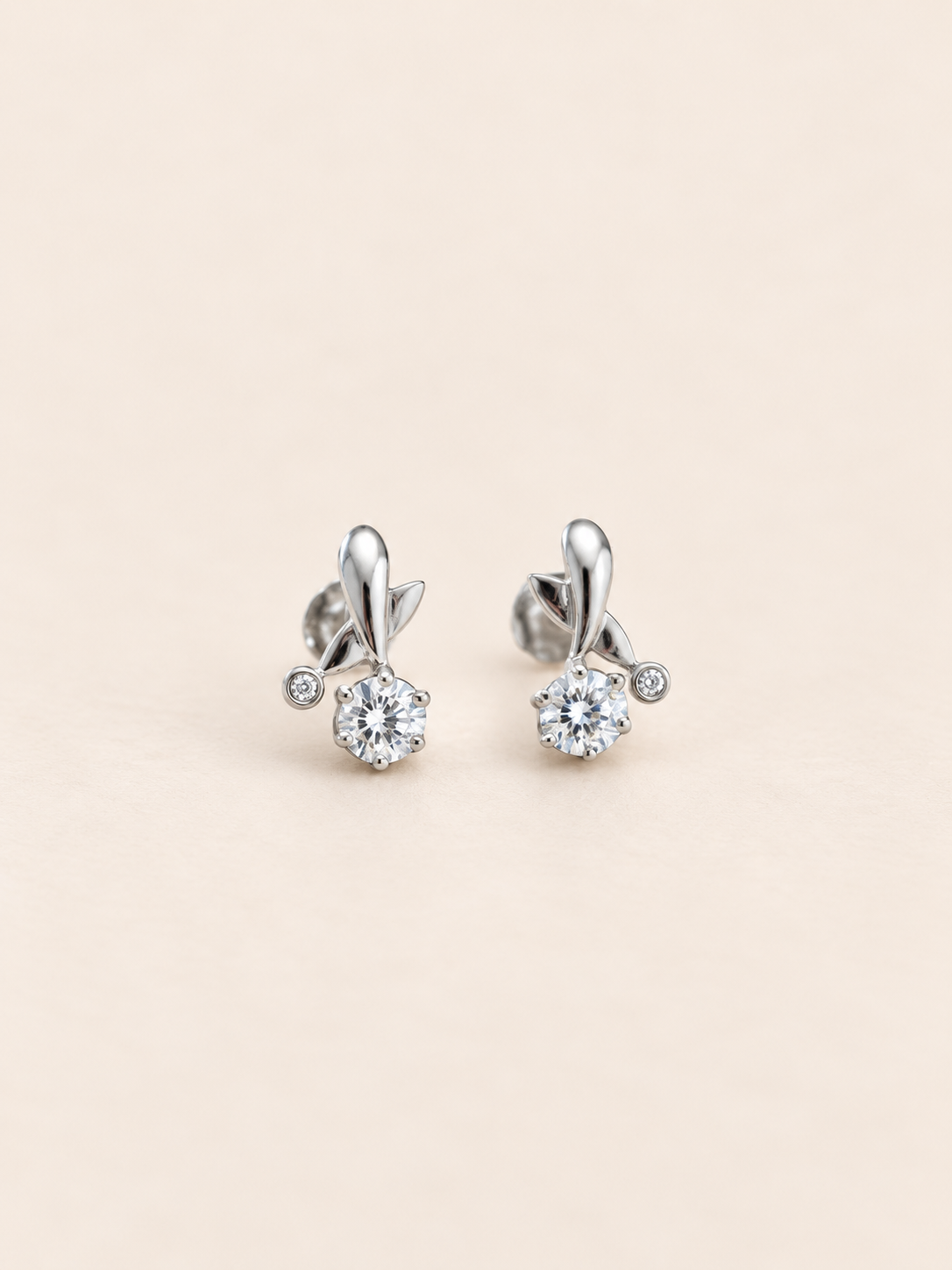 These elegant silver earrings feature a delicate floral-inspired design with sparkling zircon details.
The sculpted silver accents and brilliant centre stones add a graceful touch of sparkle to any look.