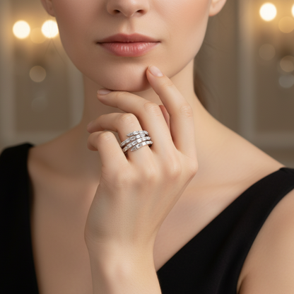 Close-up of a woman's hand wearing a silver spiral lumina ring by maela with a blurred background